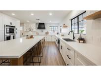 Modern kitchen featuring white cabinetry, black hardware, quartz countertops, and stainless steel appliances at 1917 N Moapa Valley Blvd, Logandale, NV 89021