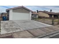Charming single-story home with a two car garage and a traditional front yard in need of landscaping at 2441 Oak Glen Way, Las Vegas, NV 89115