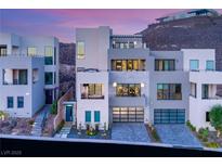 Striking three-story modern home with multi-car garage and manicured front yard at 358 Solitude Peak Ln, Henderson, NV 89012