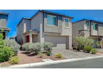 Modern two-story home featuring a two-car garage, desert landscaping, and a neutral color palette at 4160 Elegant Chateau St, Las Vegas, NV 89135