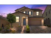 Inviting two-story home featuring a meticulously landscaped front yard and an attached two-car garage at 465 Cabral Peak St, Las Vegas, NV 89138