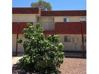 Exterior view of a multi-Gathering home with muted color scheme, a small balcony, and minimal landscaping at 5440 Swenson St # 18, Las Vegas, NV 89119