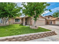 Charming single-story home featuring a well-manicured lawn and mature trees in a desirable neighborhood at 601 Cragin Park Dr, Las Vegas, NV 89107