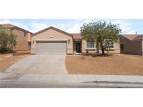 Charming single-story home featuring a low maintenance desert landscape and attached two-car garage at 6140 Passionate Ct, North Las Vegas, NV 89031