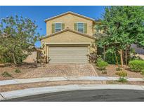 Charming two-story home with a two-car garage, beautiful landscaping, and a brick driveway at 625 Loyalty Ct, Henderson, NV 89011