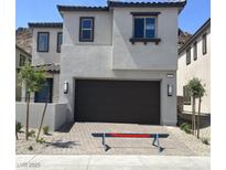 Charming two-story home with a two-car garage and well-maintained landscaping at 64 Via Montoro, Henderson, NV 89011
