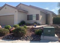 Charming single-story home with low-maintenance landscaping and a two-car garage at 6412 Starling Mesa St, North Las Vegas, NV 89086