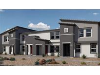Modern townhomes with contemporary paint schemes and desert landscaping out front at 7371 Hayes Harbor Ct Dr # Lot 209, North Las Vegas, NV 89084
