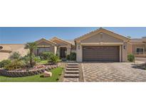 Charming home featuring a well-manicured front yard with desert landscaping and a paved driveway at 10013 Hunter Springs Dr, Las Vegas, NV 89134