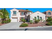 Charming two-story home with a terracotta tile roof, well-maintained landscaping, and a two-car garage at 11569 Velicata Ct, Las Vegas, NV 89138