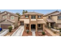 Charming two-story home featuring a cozy front porch and a well-maintained landscape at 2199 Timescape Ct, Las Vegas, NV 89123