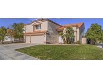 Charming two-story home with a two-car garage, well-maintained lawn, and desert landscaping at 2732 Dune Cove Rd, Las Vegas, NV 89117