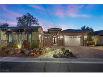Beautiful single-story home featuring a stone pathway, desert landscaping, and a two-car garage at 2749 Liberation Dr, Henderson, NV 89044