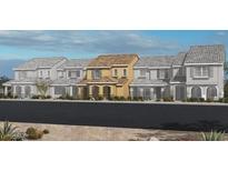 New two-story home with unique front exterior featuring a light tan facade and well-manicured landscaping at 2766 Via Napoli, Henderson, NV 89044