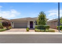 Charming single-story home with a well-manicured front yard, desert landscaping, and a tile roof under a blue sky at 2915 Moulton Crest Ave, Henderson, NV 89044