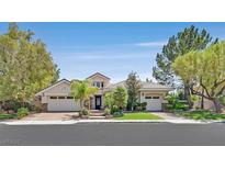 Charming home featuring a well-manicured front yard with mature trees and a multi-car garage at 3000 Hammerwood Dr, Las Vegas, NV 89135