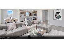 Open-concept living room and kitchen area with modern furnishings and stainless steel appliances at 329 Blossom Wind St # Lot 14, Henderson, NV 89015
