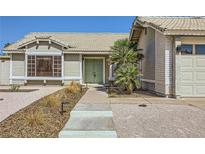 Charming single-story home featuring desert landscaping, a two-car garage, and a quaint front entryway at 335 Simon Bolivar Dr, Henderson, NV 89014