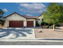 Charming single-story home featuring a three-car garage, neutral stucco, and manicured desert landscaping at 5016 Wayfaring Tree Ave, Las Vegas, NV 89131