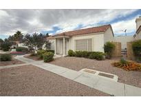 Charming single-story home features a well-maintained front yard with mature landscaping at 5424 Comchec Way # 101, Las Vegas, NV 89108