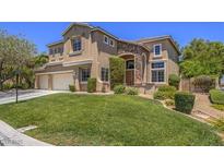 Charming two-story home with a well-manicured lawn, three car garage, and stone accents at 8106 Eagle Clan Ct, Las Vegas, NV 89131