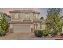 Charming two-story home featuring a manicured front yard and an attached two-car garage at 8220 Chimney Bluffs St, North Las Vegas, NV 89085