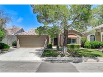 Charming single-story home featuring desert landscaping, mature trees, and a spacious two-car garage at 9220 Evergreen Canyon Dr, Las Vegas, NV 89134