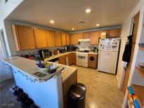 Functional kitchen features ample cabinet space and a breakfast bar for casual dining at 9580 W Reno Ave # 283, Las Vegas, NV 89148