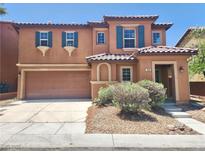 Two-story home featuring a terracotta exterior, a two-car garage and low maintenance landscaping at 11185 Saddle Iron St, Las Vegas, NV 89179