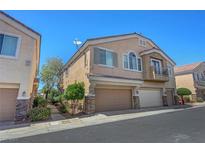 Inviting two-story home featuring a two-car garage, desert landscaping and neutral color palette at 1574 Ward Frontier Ln, Henderson, NV 89002