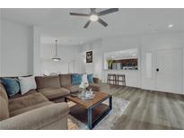 Spacious living room featuring an open floor plan and modern hardwood flooring throughout at 2325 Windmill Pkwy # 1023, Henderson, NV 89074
