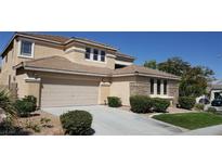 Charming two-story home featuring a two-car garage, brick accents, and manicured landscaping on a sunny day at 2384 Stansbury Ct, Henderson, NV 89052