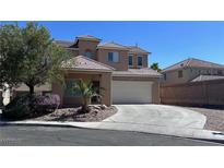 Charming two-story home featuring a circular driveway and a two-car garage, set against a clear blue sky at 3615 Dutchmans Vine Ct, North Las Vegas, NV 89081