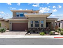 Two-story home boasting desert landscaping, a brick-paved driveway, and a two-car garage at 417 Honeybrush Ave, Henderson, NV 89011