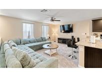 Inviting living room with a comfortable sectional sofa and a neutral color palette at 4559 Dover Straight St, Las Vegas, NV 89115