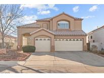 Charming two-story home featuring a three-car garage and well-maintained landscaping at 59 Desert Dawn Ln, Henderson, NV 89074