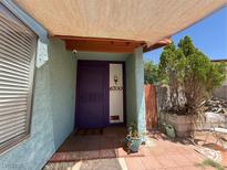 Inviting home entrance with a purple door, covered patio, and easy-to-read address numbers at 6700 Oak Valley Dr, Las Vegas, NV 89103