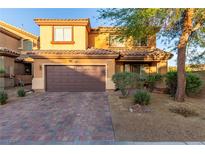 Charming two-story home features a well-maintained front yard and a two-car garage at 6954 Jacksboro Ct, North Las Vegas, NV 89084