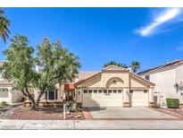 Charming single-story home featuring a three-car garage and desert landscaping at 8428 Apple Hill Ct, Las Vegas, NV 89128