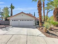 Charming single-story home featuring a two-car garage, mature landscaping, and a concrete driveway, perfect for suburban living at 8632 Skyward Ct, Las Vegas, NV 89145