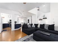 Bright living room with a contemporary design, featuring an oversized sectional and wood floors at 9029 Tumblewood Ave, Las Vegas, NV 89143
