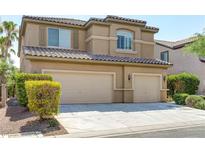 Inviting two-story home featuring a tile roof, a three-car garage, and manicured landscaping at 11478 Bargetto Ct, Las Vegas, NV 89141
