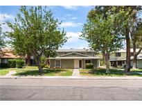 Charming home showcasing its well-maintained lawn and inviting facade nestled between mature trees at 1470 Elizabeth Ave # 1, Las Vegas, NV 89119