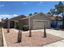 Charming single story home showcasing desert landscaping and a two car garage at 1501 Wintergreen Dr, Las Vegas, NV 89128