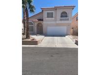 Charming two-story home with a spacious two-car garage and desert landscaping at 1551 Echo Falls Ave, Las Vegas, NV 89183