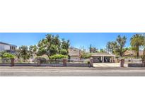 Charming single-story home featuring a well-manicured front yard and inviting curb appeal at 2045 S Tenaya Way, Las Vegas, NV 89117