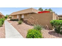 Charming single-story exterior with desert landscaping and private courtyard at 2569 Paradise Village Way, Las Vegas, NV 89120