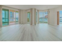 Bright, open living room features light wood floors, neutral walls and multiple windows with city views at 2747 Paradise Rd # 2305, Las Vegas, NV 89109