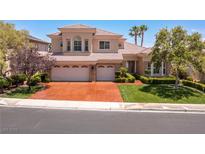 Two-story home boasts a well-manicured lawn, three-car garage and mature trees for added curb appeal at 2846 Barrow Downs St, Las Vegas, NV 89135