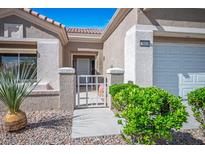 Charming home featuring a gated front entrance, desert landscaping, and a two-car garage at 2913 Laverton Dr, Las Vegas, NV 89134